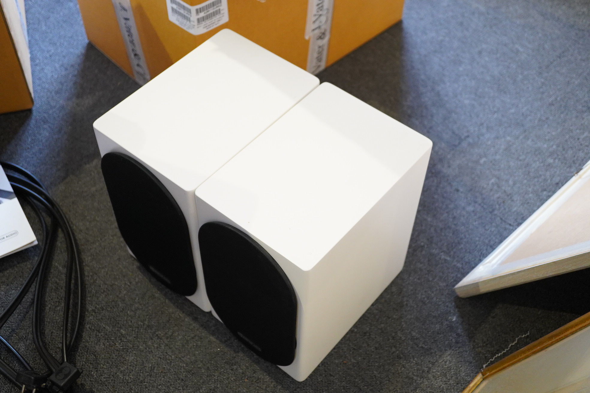A pair of Monitor Audio Silver Series ‘Silver 50’ stereo monitor speakers in satin white cases, height 27cm, width 16.5cm, depth 25cm, together with the silver series specification booklet and two related audio cables